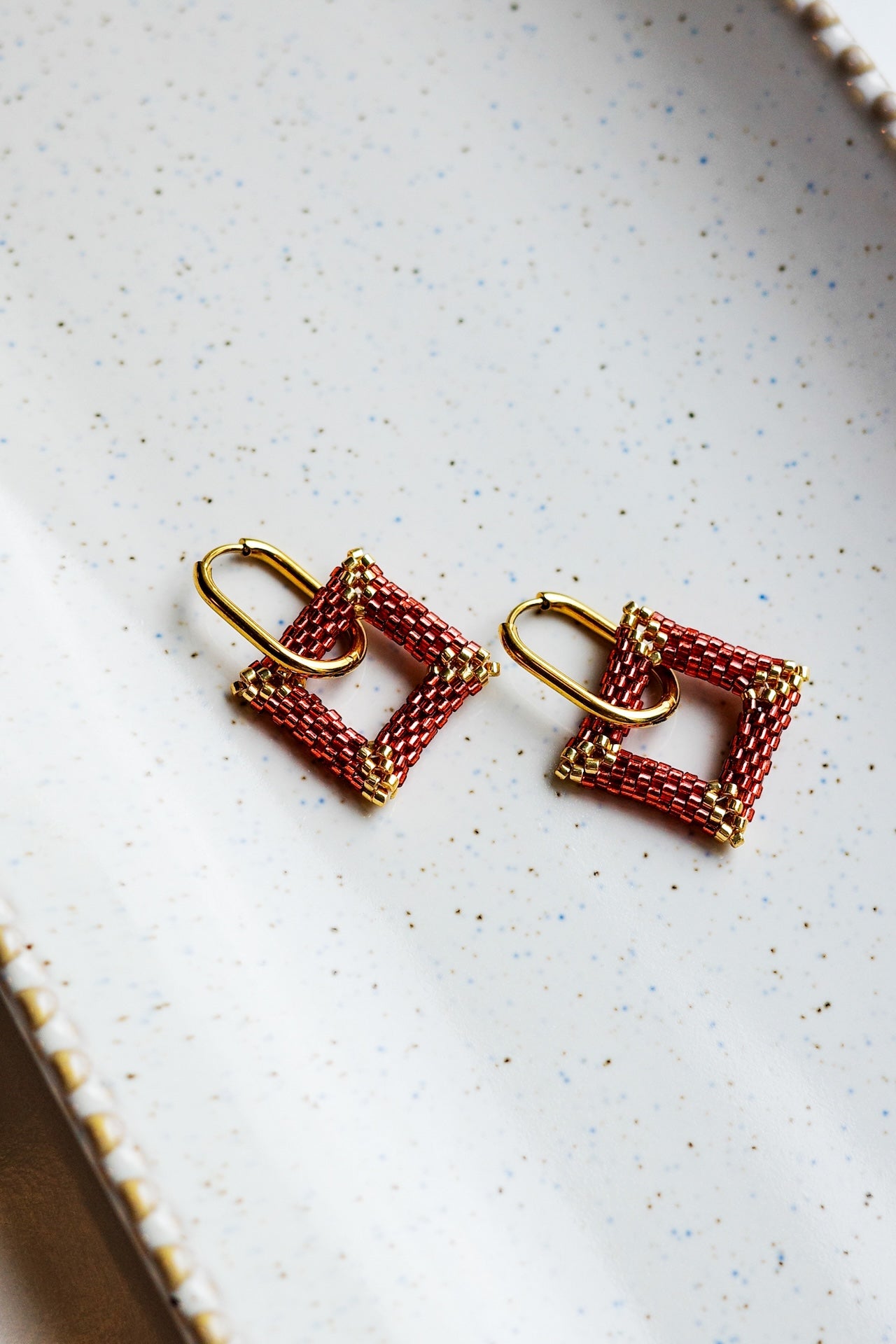 Handmade beaded gold and red square earrings. 